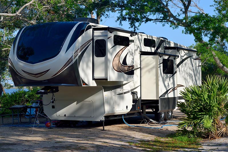 Towable camper parked before scheduling rv inspection services 